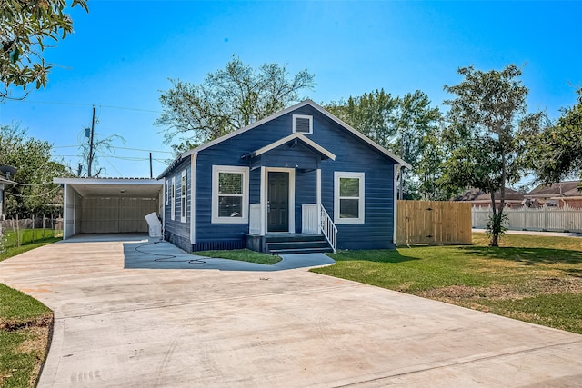 view of front of house featuring a front lawn and a carport