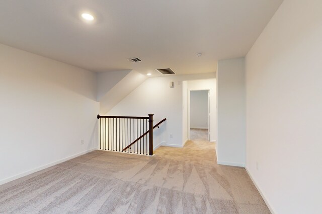 unfurnished room featuring light carpet