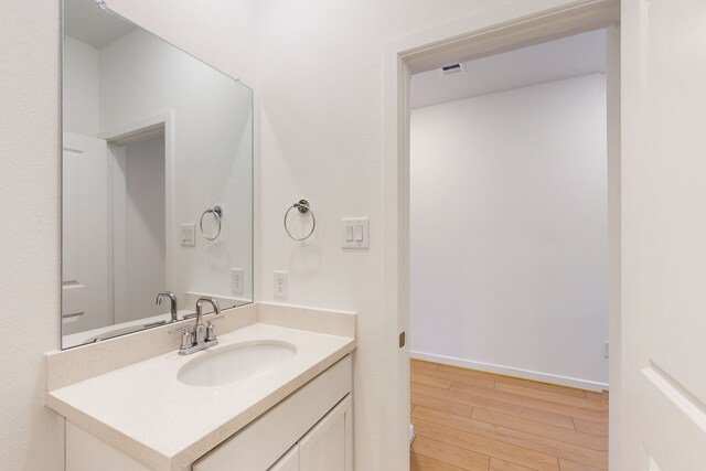 bathroom featuring vanity and wood-type flooring