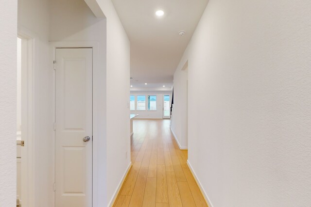 hallway with light hardwood / wood-style flooring