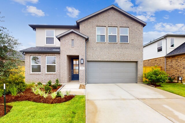 view of front facade featuring a front yard and a garage