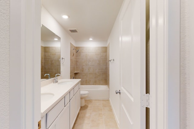 full bathroom with vanity, tiled shower / bath combo, toilet, and tile patterned floors