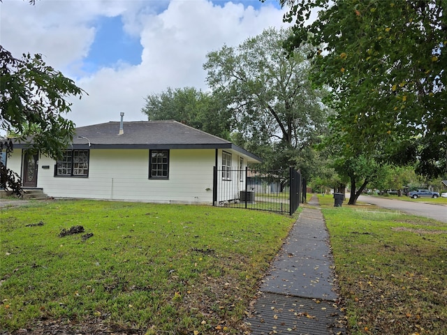 view of side of home with a yard