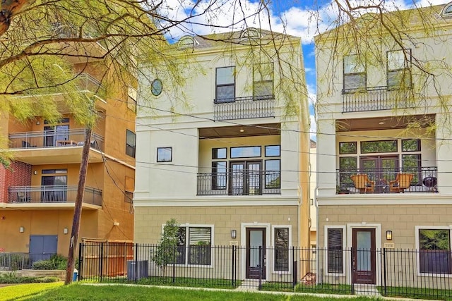 exterior space with a balcony and a front yard