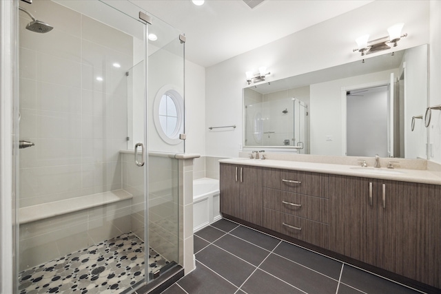 bathroom with vanity, a shower with shower door, and tile patterned flooring