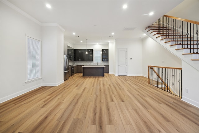 unfurnished living room with light wood-type flooring and crown molding