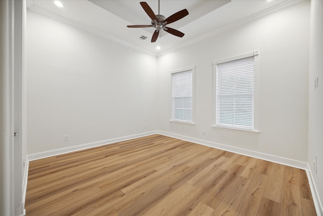 spare room with ornamental molding, light wood-type flooring, and ceiling fan