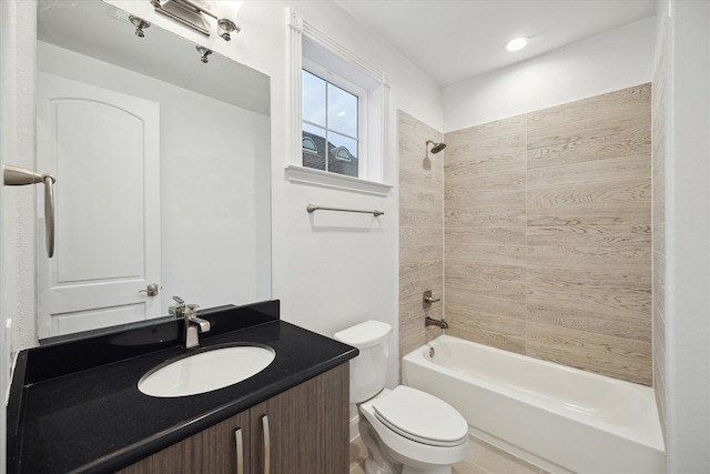 full bathroom with vanity, tiled shower / bath, and toilet