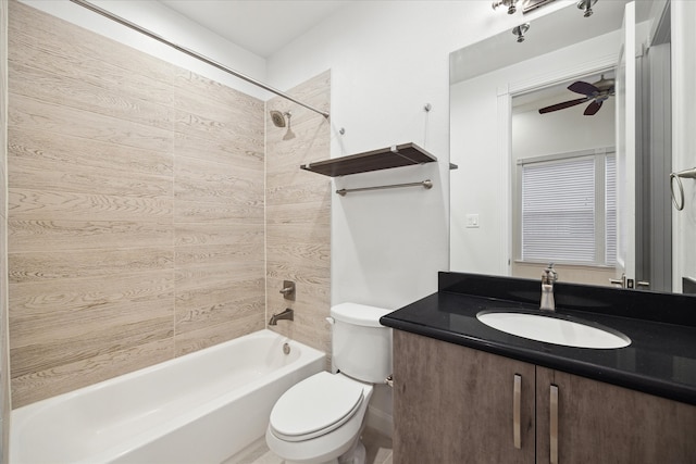 full bathroom featuring ceiling fan, vanity, toilet, and tiled shower / bath combo