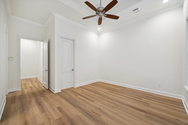 empty room with light hardwood / wood-style floors, ceiling fan, and crown molding