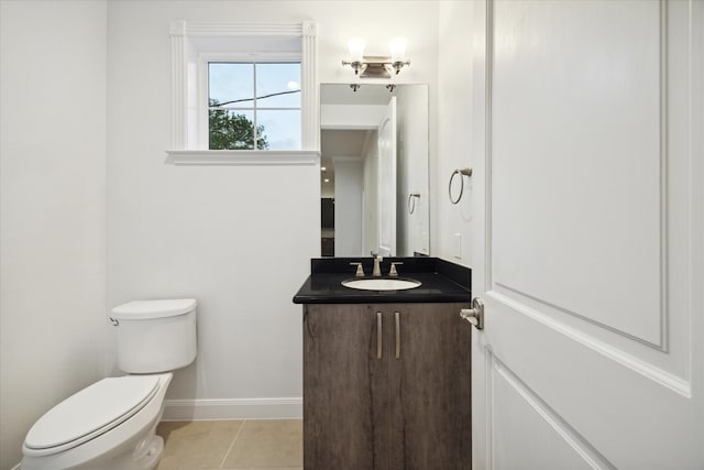 bathroom with vanity, tile patterned flooring, and toilet