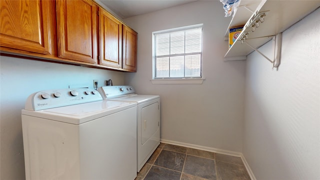 clothes washing area featuring washing machine and clothes dryer and cabinets