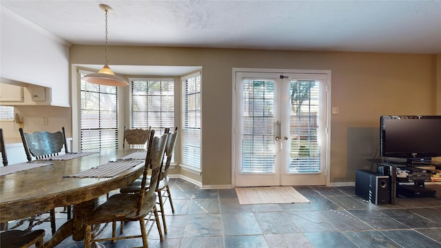 dining area with plenty of natural light, french doors, and ornamental molding