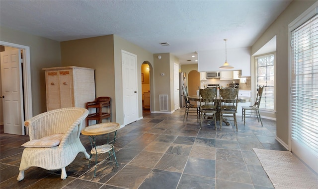 dining room featuring a textured ceiling