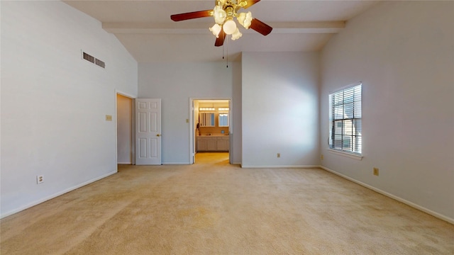 unfurnished bedroom featuring ceiling fan, beam ceiling, light carpet, and connected bathroom