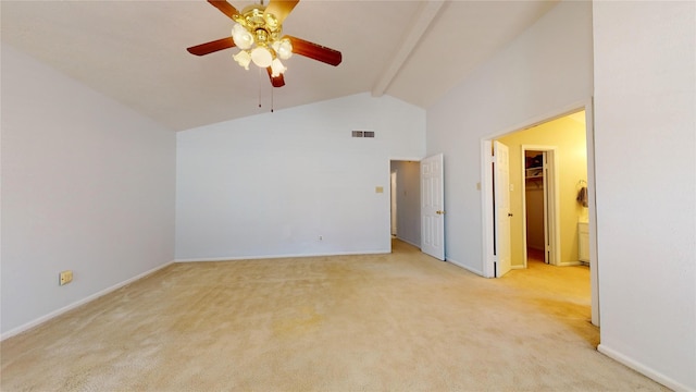 spare room featuring beamed ceiling, ceiling fan, light carpet, and high vaulted ceiling