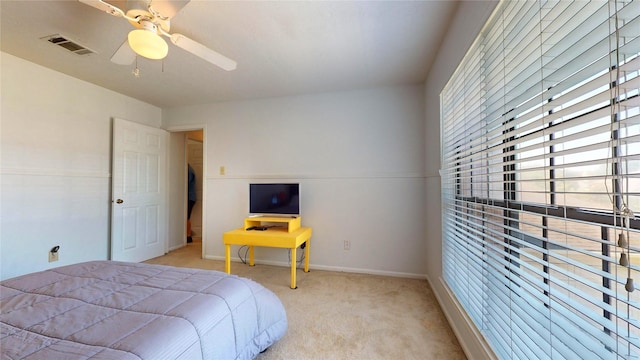 bedroom featuring light carpet and ceiling fan