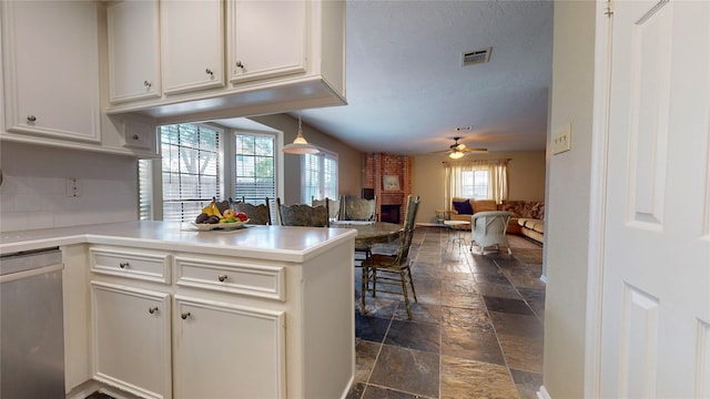 kitchen featuring kitchen peninsula, white cabinets, ceiling fan, decorative light fixtures, and dishwasher