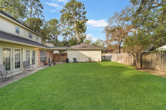 view of yard with french doors and a patio