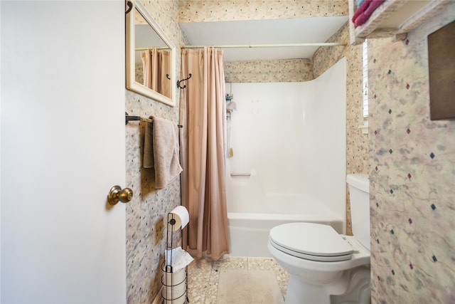 bathroom featuring shower / bath combination with curtain and toilet