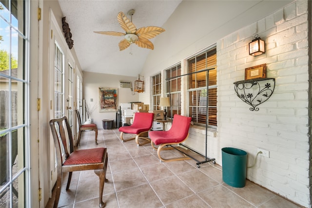 sunroom with ceiling fan and vaulted ceiling