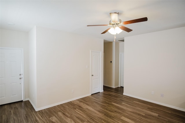 spare room with ceiling fan and dark hardwood / wood-style floors