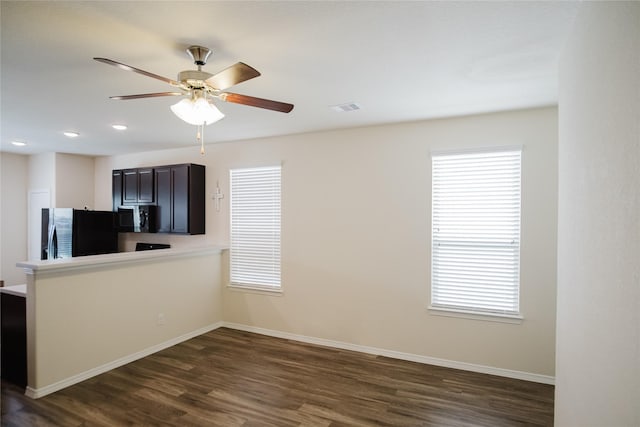 kitchen featuring dark wood-type flooring, ceiling fan, stainless steel fridge with ice dispenser, and a wealth of natural light