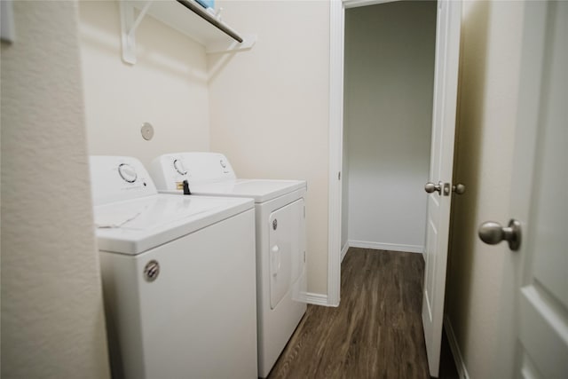 washroom with dark wood-type flooring and washing machine and clothes dryer