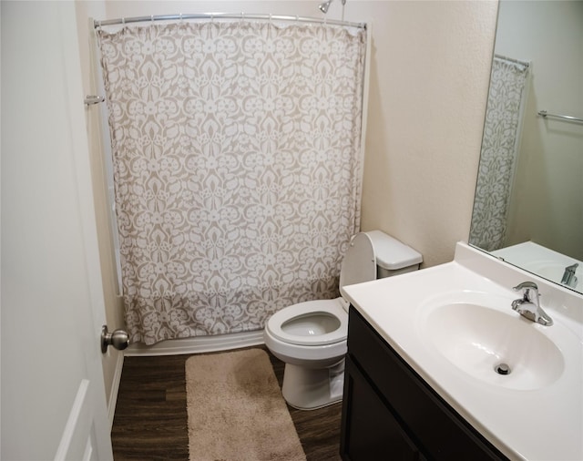 full bathroom with shower / bathtub combination with curtain, vanity, toilet, and hardwood / wood-style floors