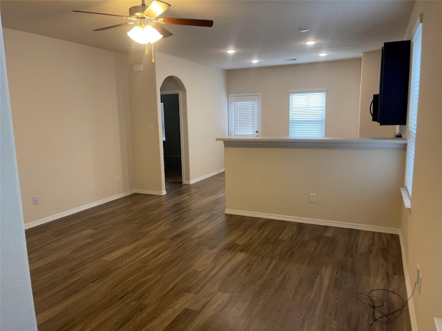 unfurnished room with dark wood-type flooring and ceiling fan