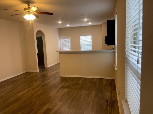 spare room with dark wood-type flooring and ceiling fan