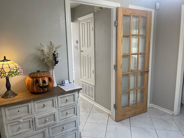 hallway featuring light tile patterned floors