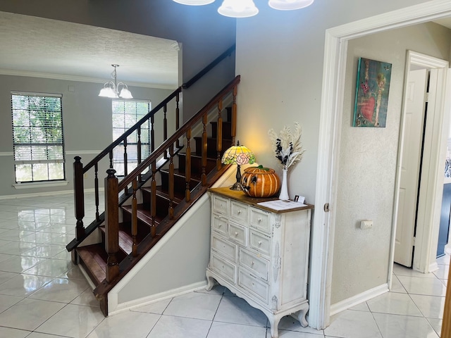 stairs featuring tile patterned flooring, ornamental molding, a textured ceiling, and a chandelier