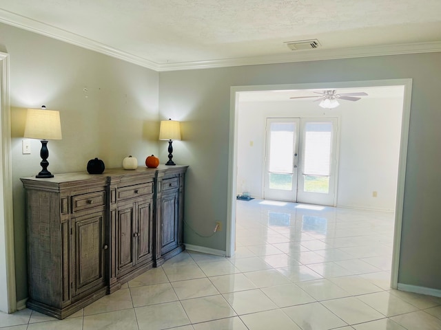 hallway featuring french doors, crown molding, a textured ceiling, and light tile patterned flooring