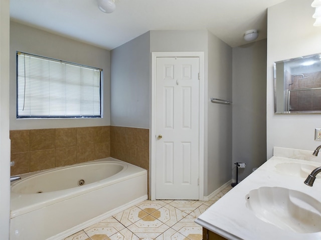 bathroom featuring vanity, tile patterned floors, and a bathtub