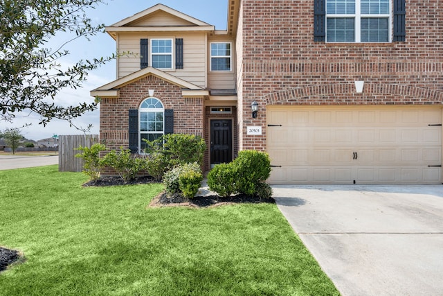 view of front facade with a front yard and a garage