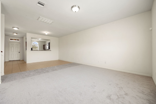 unfurnished living room featuring light carpet