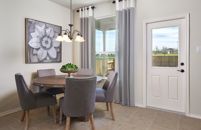 dining space featuring an inviting chandelier, light tile patterned flooring, and a wealth of natural light