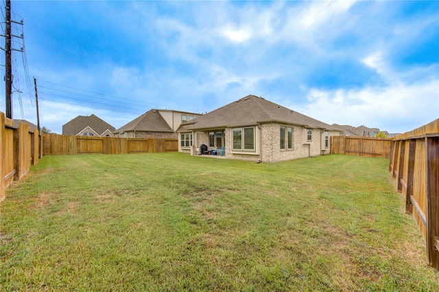 rear view of property featuring a lawn