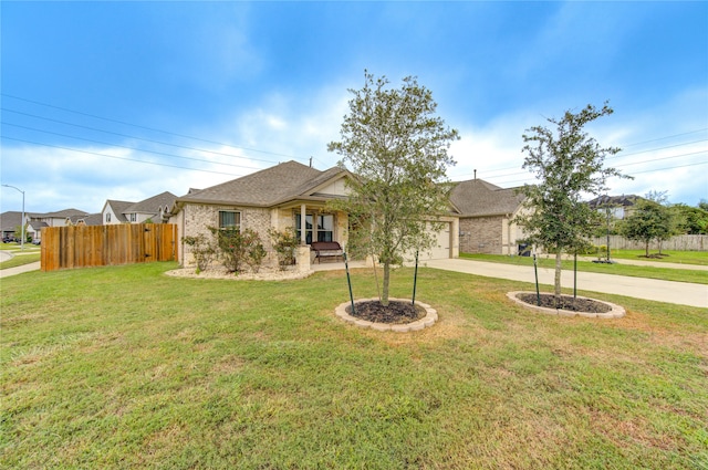 view of front of home featuring a front yard and a garage