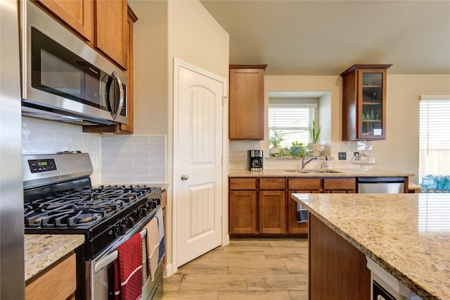 2446 Wembley Way, Rosenberg, TX 77471 - kitchen with stainless steel appliances, a sink, backsplash, and healthy amount of natural light