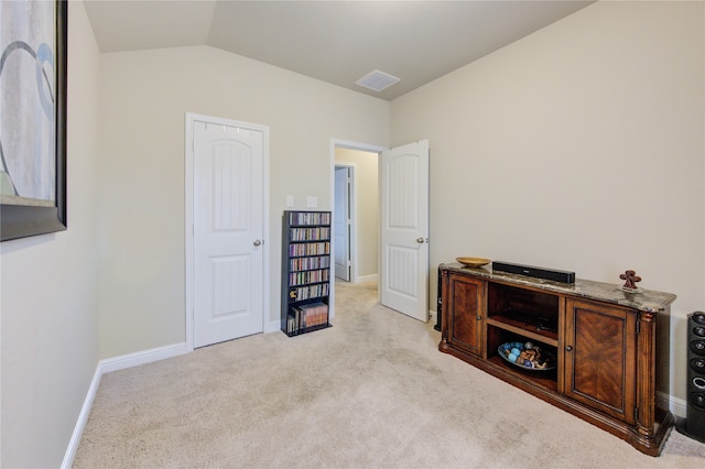 bedroom featuring light carpet and lofted ceiling