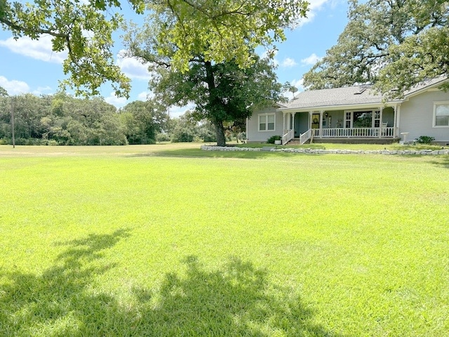 view of yard with covered porch