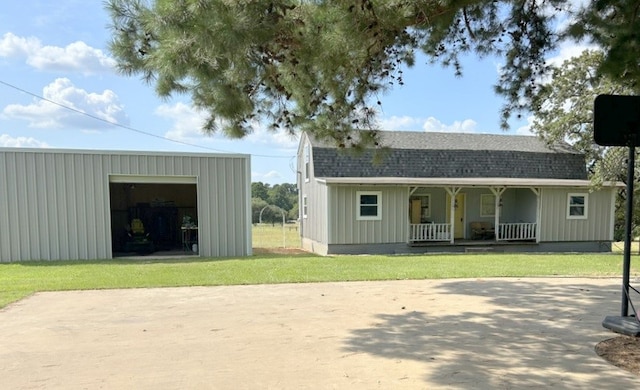 exterior space with a porch, a garage, and a lawn