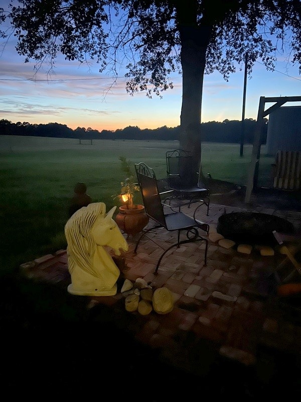 patio terrace at dusk featuring a fire pit