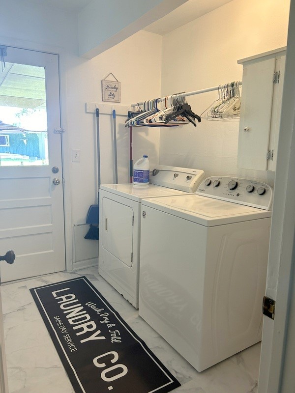 clothes washing area featuring washing machine and clothes dryer