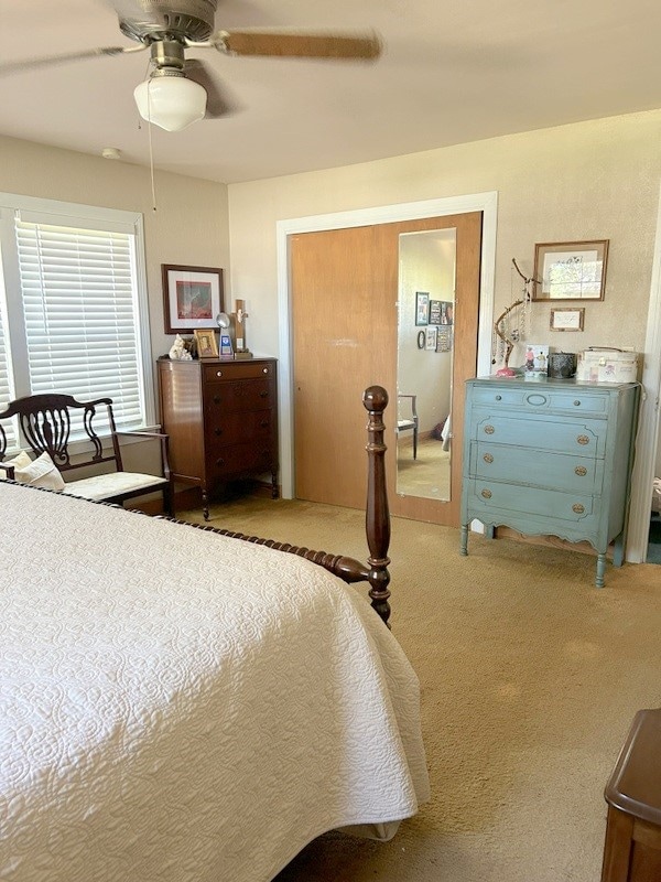 bedroom with light colored carpet and ceiling fan