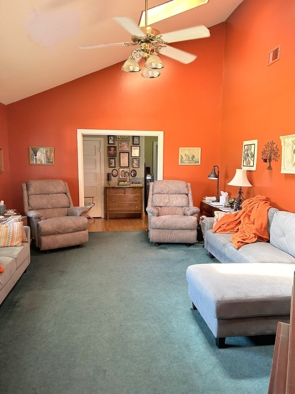 living room featuring carpet, high vaulted ceiling, and ceiling fan