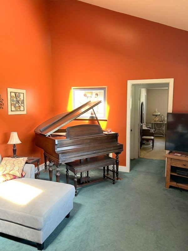 misc room featuring carpet and vaulted ceiling