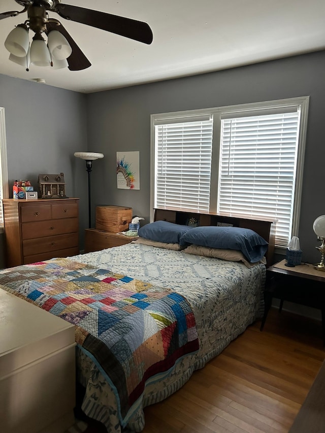 bedroom with wood-type flooring and ceiling fan